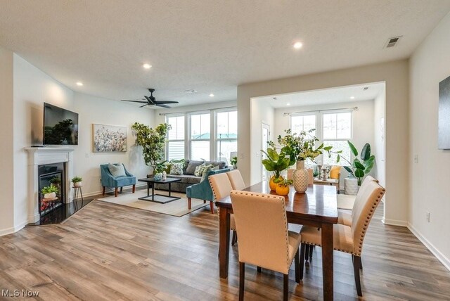 855-2 Dipper Ln, Aurora, OH 44202 - dining room featuring recessed lighting, wood finished floors, a glass covered fireplace, and ceiling fan
