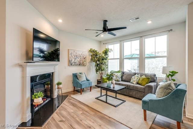 855-2 Dipper Ln, Aurora, OH 44202 - living room featuring ceiling fan, wood finished floors, recessed lighting, and a glass covered fireplace