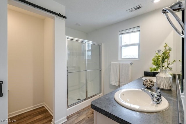 855-2 Dipper Ln, Aurora, OH 44202 - bathroom featuring wood finished floors, a shower stall, and vanity