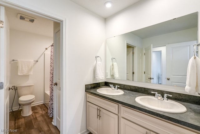 855-2 Dipper Ln, Aurora, OH 44202 - full bathroom featuring double vanity, wood finished floors, and shower / tub combo with curtain