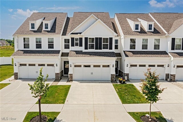 855-2 Dipper Ln, Aurora, OH 44202 - townhome / multi-family property featuring a garage, driveway, and stone siding