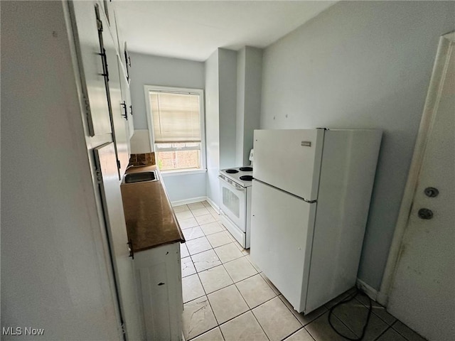 15610 Van Aken Blvd Unit 4, Shaker Heights, OH 44120 - kitchen featuring white appliances, light tile patterned flooring, and dark countertops