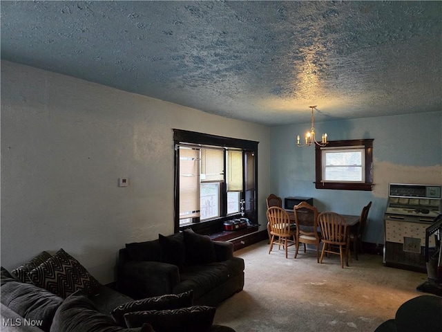 38 Royal Pl, Akron, OH 44310 - living area featuring carpet flooring, a textured ceiling, and a chandelier