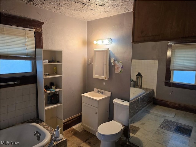 38 Royal Pl, Akron, OH 44310 - full bathroom with baseboards, toilet, vanity, and a garden tub