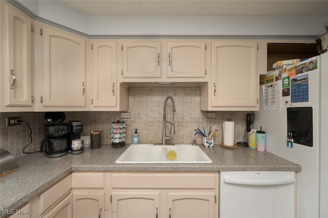 kitchen with a sink, backsplash, and white appliances