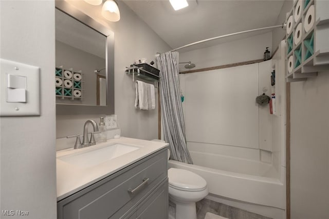 bathroom featuring toilet, shower / bath combination with curtain, wood finished floors, and vanity