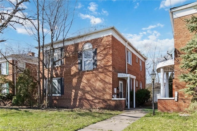 17809 Harvard Ave, Cleveland, OH 44128 - view of side of home with a lawn and brick siding