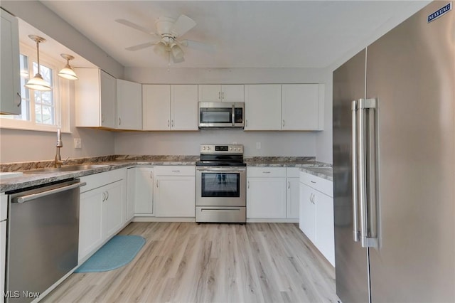 44 Hickory Dr, Little Hocking, OH 45742 - kitchen with light wood-type flooring, a sink, ceiling fan, white cabinets, and appliances with stainless steel finishes