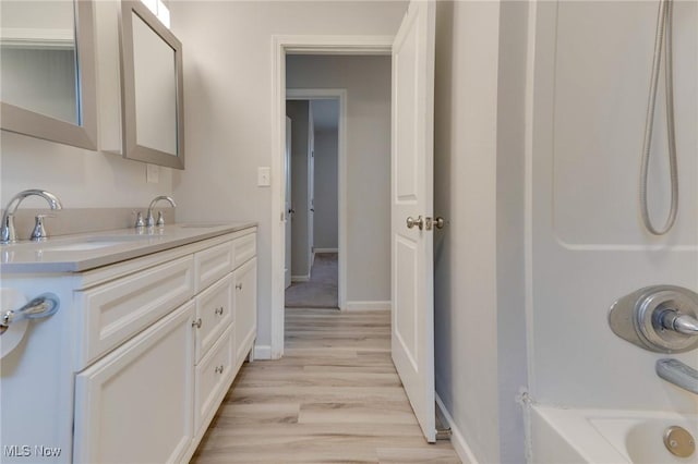 44 Hickory Dr, Little Hocking, OH 45742 - bathroom with baseboards, wood finished floors, vanity, and shower / bath combination