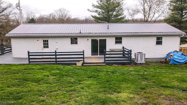 44 Hickory Dr, Little Hocking, OH 45742 - back of property with fence, a deck, metal roof, central AC unit, and a yard