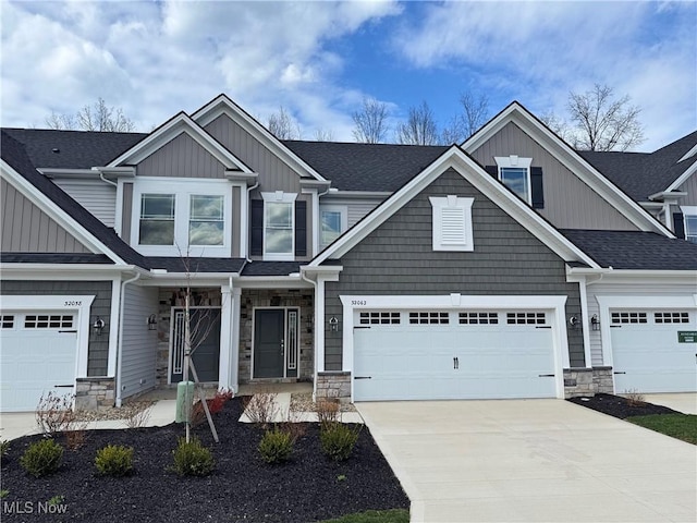 32062 Tuscan Ln Unit L-4, Avon Lake, OH 44012 - craftsman-style house featuring stone siding, driveway, board and batten siding, and an attached garage