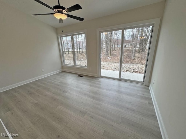 32062 Tuscan Ln Unit L-4, Avon Lake, OH 44012 - spare room featuring baseboards, visible vents, a ceiling fan, and wood finished floors