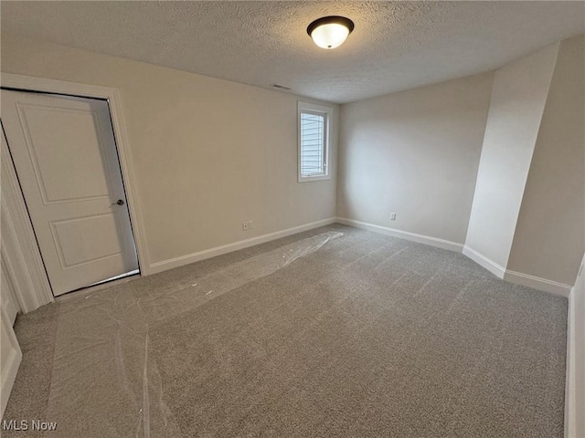 32062 Tuscan Ln Unit L-4, Avon Lake, OH 44012 - empty room with baseboards, a textured ceiling, and carpet