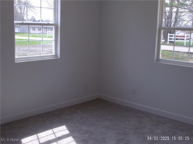 carpeted empty room with baseboards
