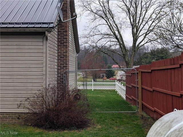 44790 County Road 23, Coshocton, OH 43812 - view of side of home with a chimney, fence, and a yard