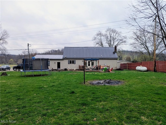44790 County Road 23, Coshocton, OH 43812 - rear view of property featuring a yard, metal roof, fence, and a trampoline
