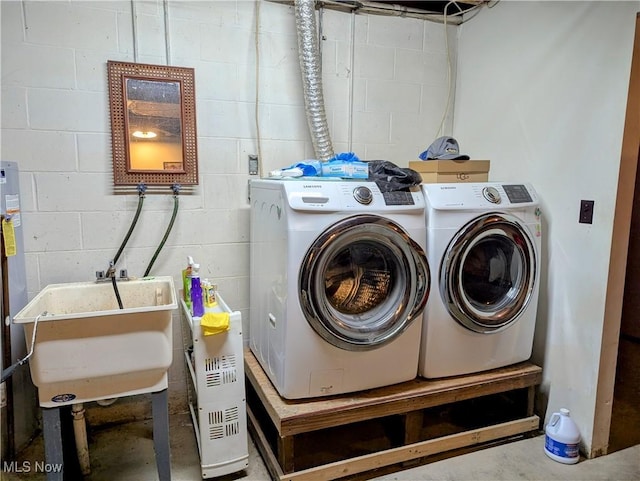 44790 County Road 23, Coshocton, OH 43812 - laundry room featuring washing machine and dryer, concrete block wall, and a sink