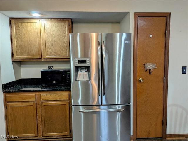 44790 County Road 23, Coshocton, OH 43812 - kitchen featuring dark stone countertops, black microwave, stainless steel refrigerator with ice dispenser, and brown cabinets