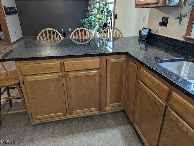 44790 County Road 23, Coshocton, OH 43812 - kitchen featuring brown cabinetry, dark stone countertops, and a peninsula