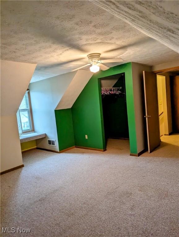 44790 County Road 23, Coshocton, OH 43812 - bonus room featuring a ceiling fan, visible vents, vaulted ceiling, and a textured ceiling