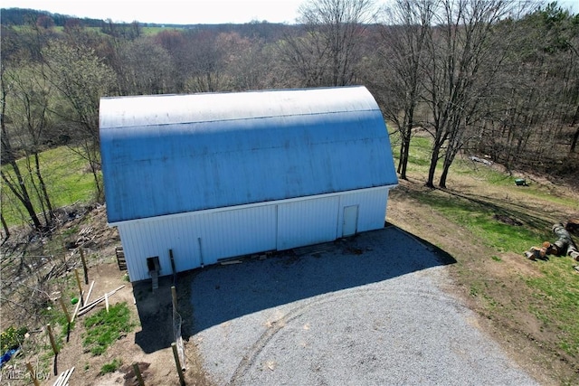 birds eye view of property with a view of trees