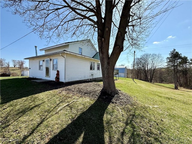 view of side of home featuring a lawn