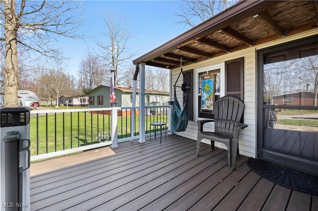 wooden deck with a lawn and a residential view