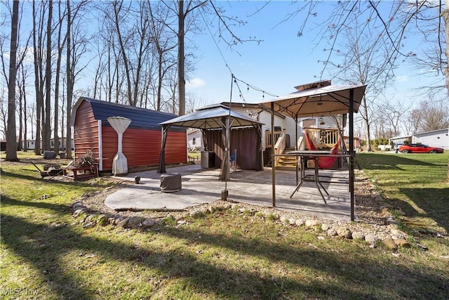 back of property featuring a lawn, a gazebo, and a patio area