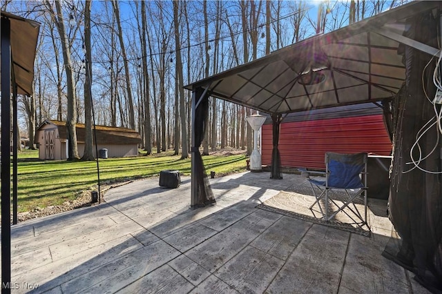 view of patio with an outbuilding and a gazebo