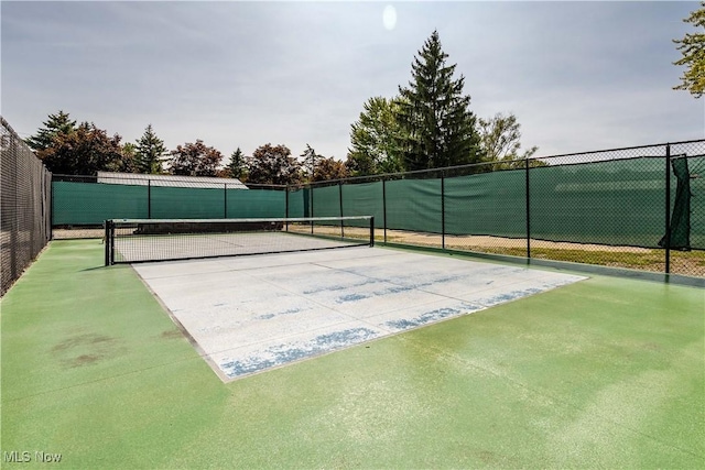 view of sport court featuring fence