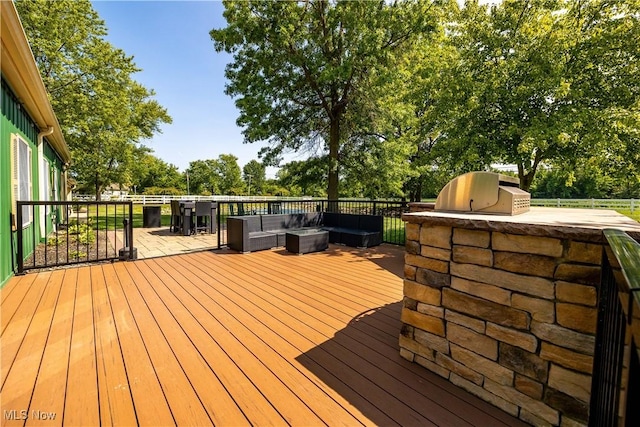 wooden deck featuring an outdoor hangout area and area for grilling