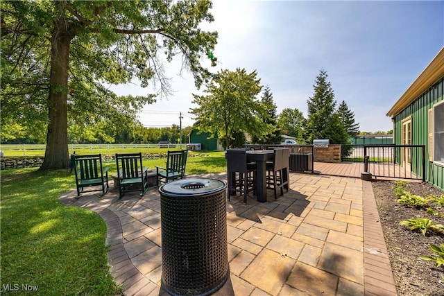 view of patio / terrace with cooling unit, an outbuilding, outdoor dining area, and fence