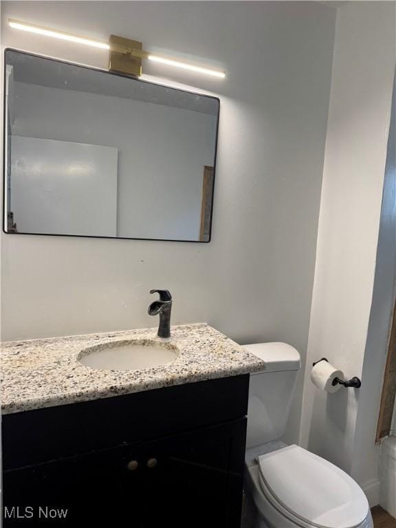 bathroom with toilet and vanity