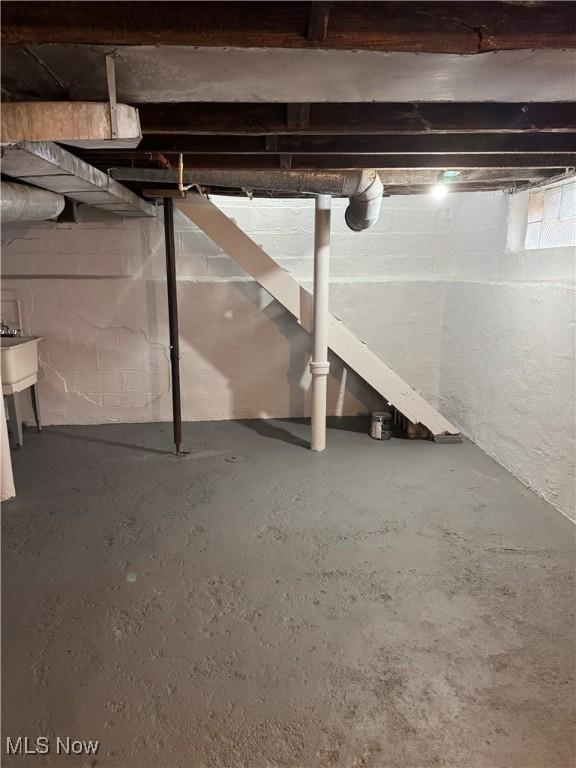 unfinished basement featuring a sink