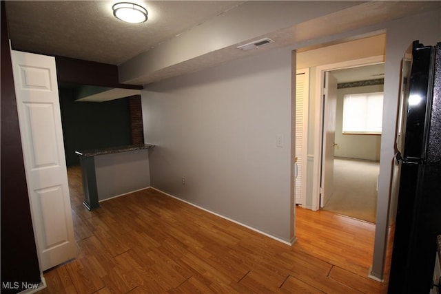 7073 Bristlewood Dr, Concord, OH 44077 - unfurnished bedroom featuring freestanding refrigerator, wood finished floors, and baseboards