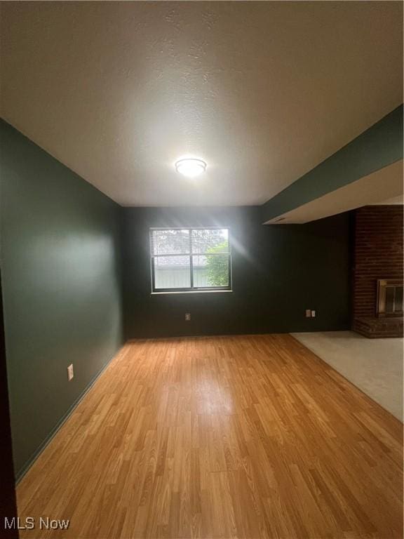 7073 Bristlewood Dr, Concord, OH 44077 - empty room featuring light wood-style flooring and a fireplace