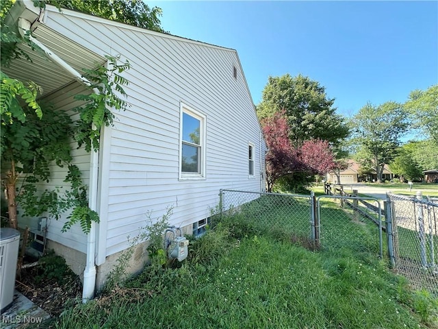 view of side of property featuring a gate and fence
