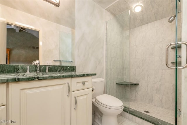 full bath featuring vanity, a stall shower, and toilet