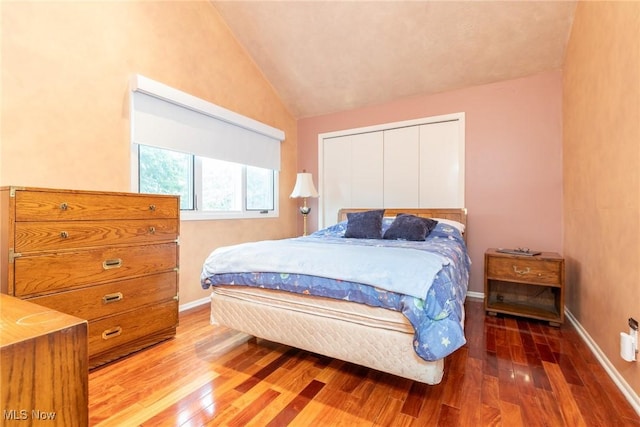 2 Salem Ct, Beachwood, OH 44122 - bedroom featuring lofted ceiling, baseboards, a closet, and wood finished floors