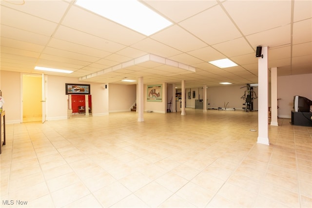 interior space featuring a drop ceiling and stairway