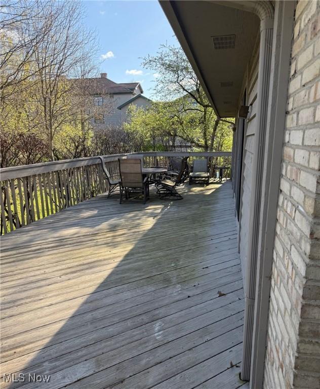 wooden deck featuring outdoor dining area