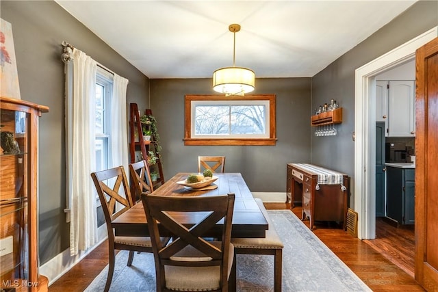 dining room featuring baseboards and wood finished floors