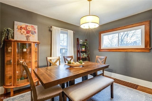 dining room with baseboards and wood finished floors