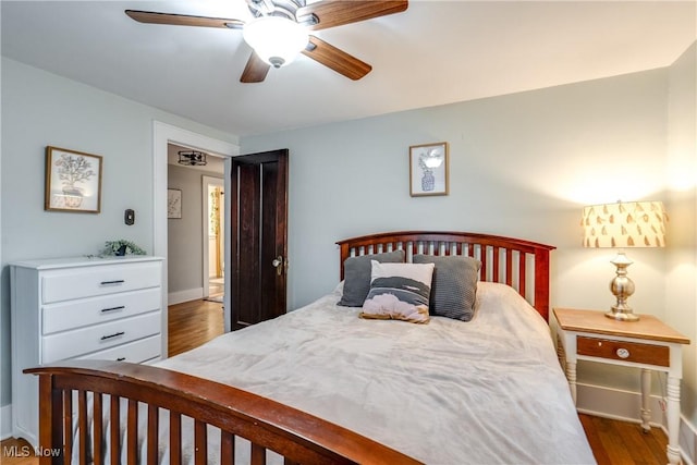 bedroom with baseboards, wood finished floors, and ceiling fan