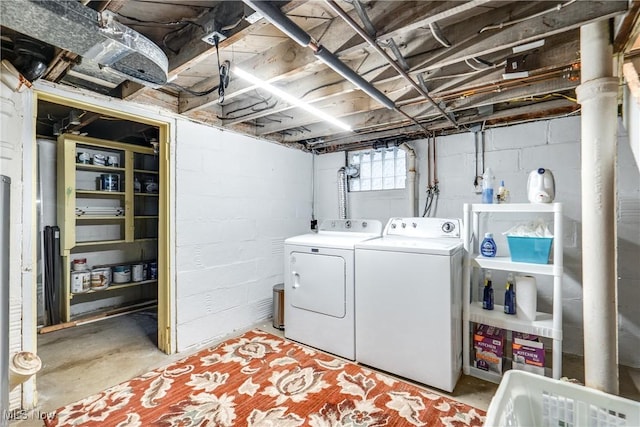 washroom with independent washer and dryer and laundry area