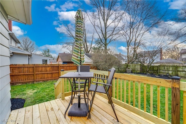 wooden terrace with a fenced backyard and a yard