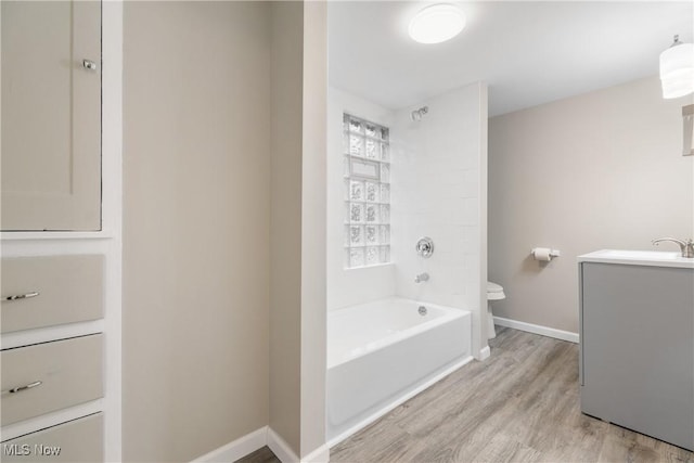 1862 17th St SW, Akron, OH 44314 - bathroom featuring shower / bathing tub combination, vanity, toilet, baseboards, and wood finished floors
