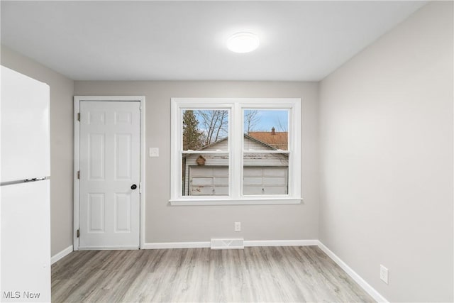 1862 17th St SW, Akron, OH 44314 - spare room with visible vents, baseboards, and wood finished floors