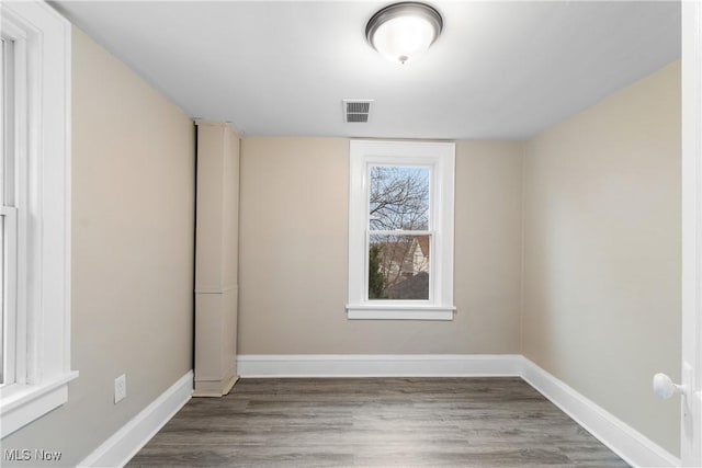 1862 17th St SW, Akron, OH 44314 - unfurnished room featuring baseboards, visible vents, and wood finished floors