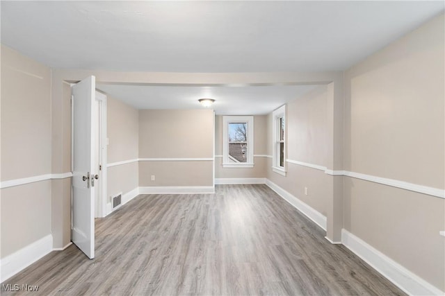 1862 17th St SW, Akron, OH 44314 - unfurnished room featuring baseboards, visible vents, and wood finished floors